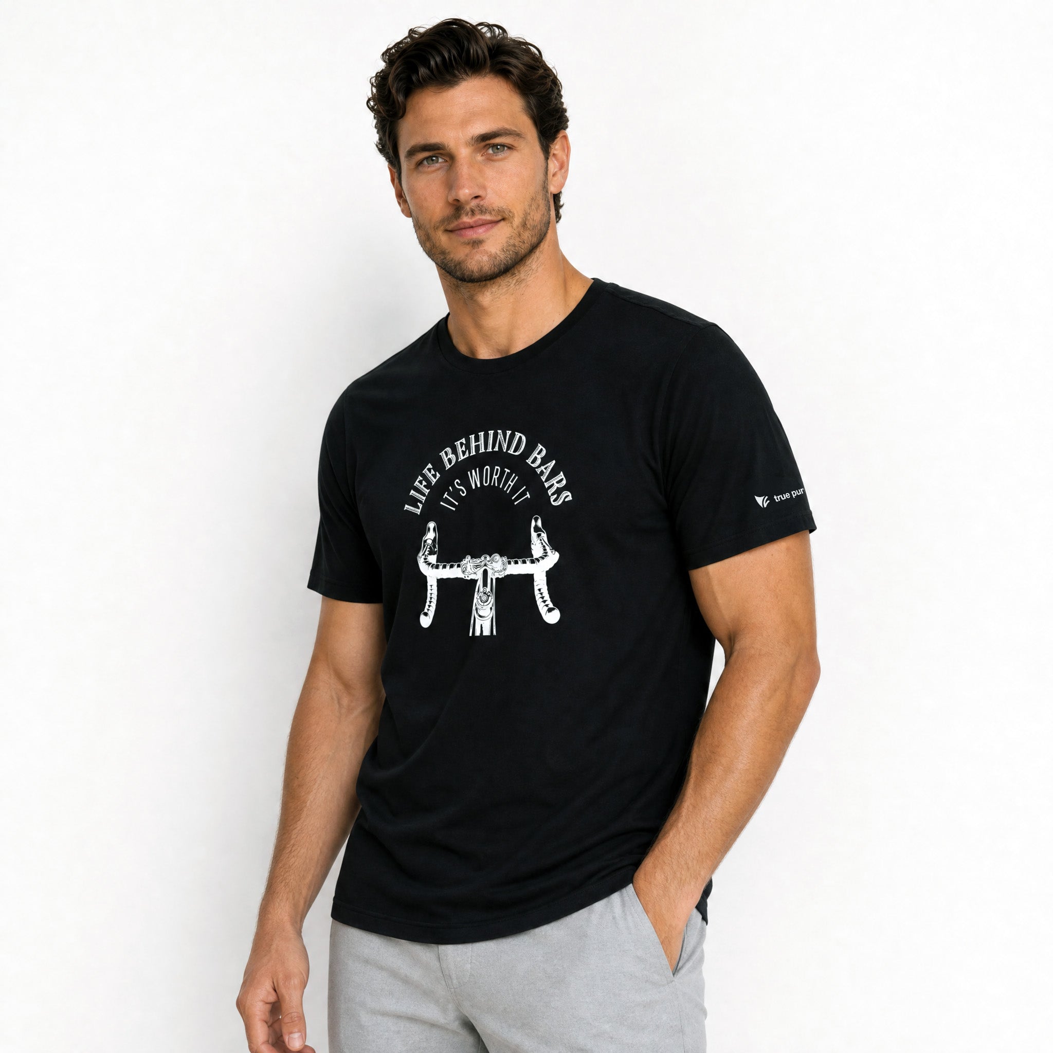 Man wearing a black t-shirt with a graphic design and text on a white background