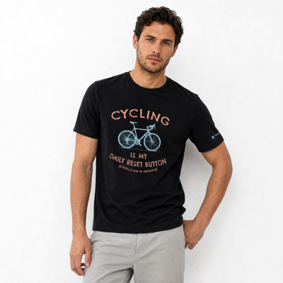 Man wearing a black t-shirt with cycling graphic and text on a white background