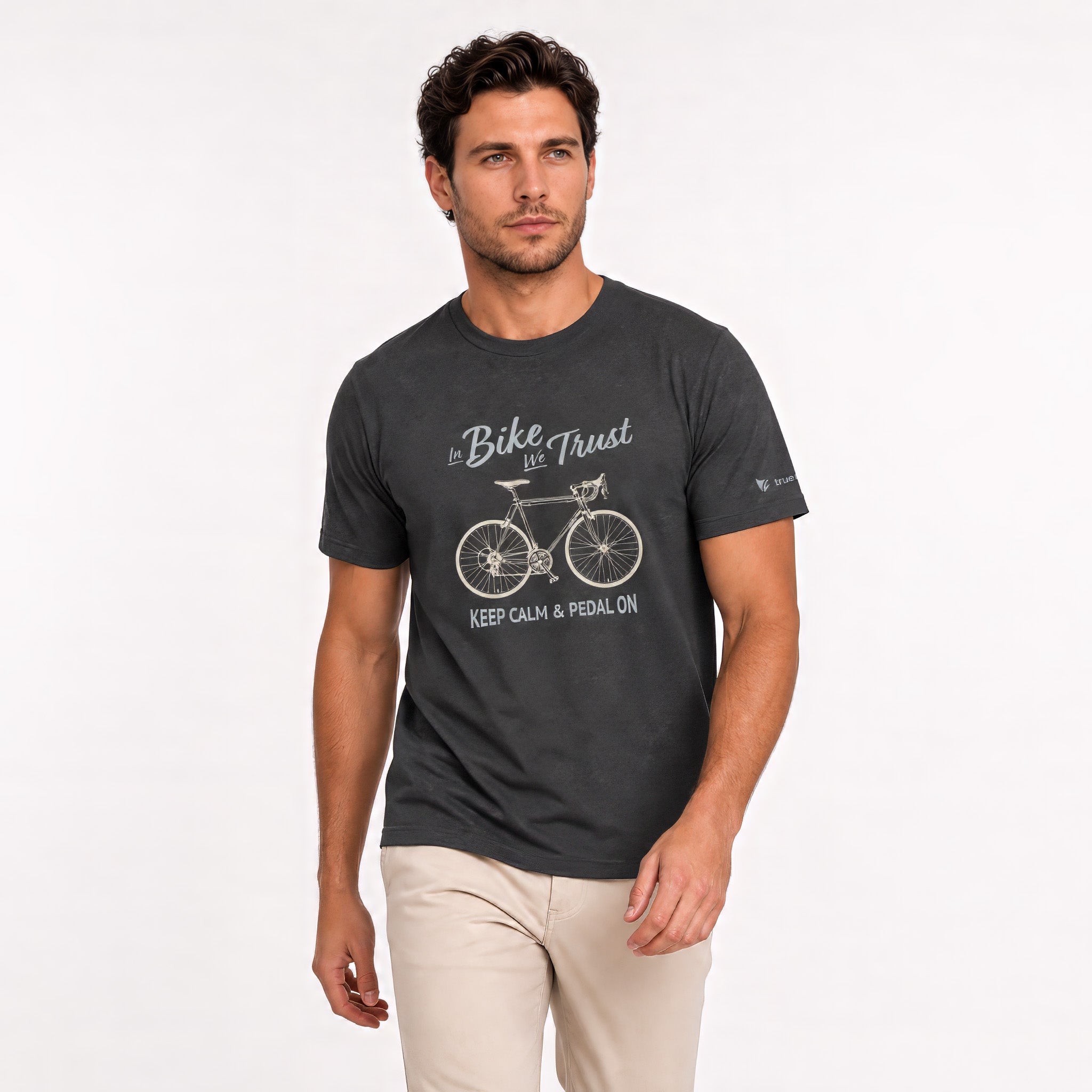 A man wearing a dark charcoal gray graphic t-shirt with a white bicycle design and the text 'Bike is Trust' and 'KEEP CALM & PEDAL ON'.