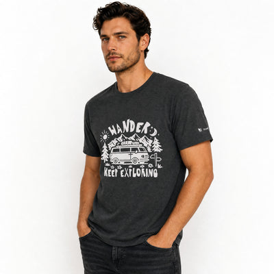 Man wearing a heather grey t-shirt with a graphic design and text on a white background