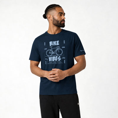 Man wearing a navy blue t-shirt with 'Bike Vibes' graphic on a white background
