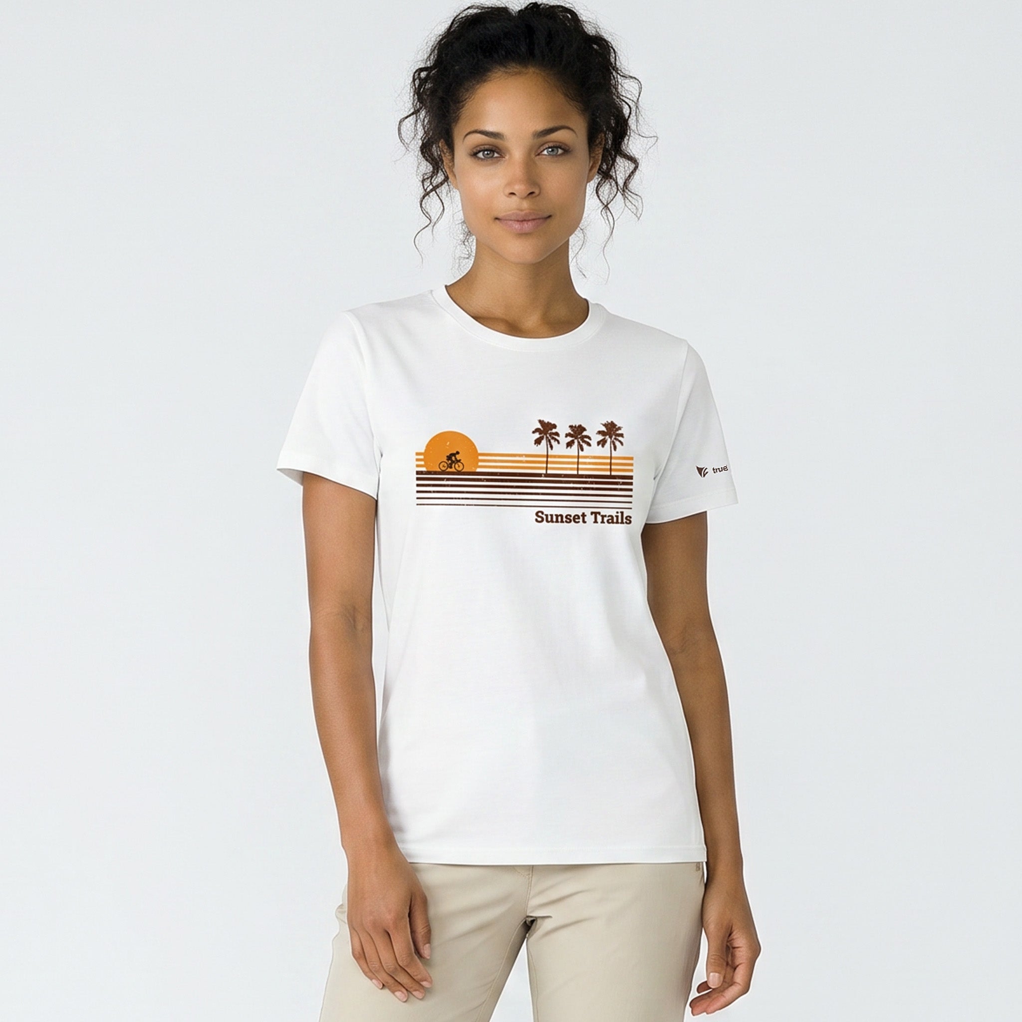 Woman wearing a white t-shirt with a graphic design on a plain background