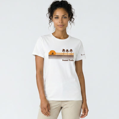Woman wearing a white t-shirt with a graphic design on a plain background