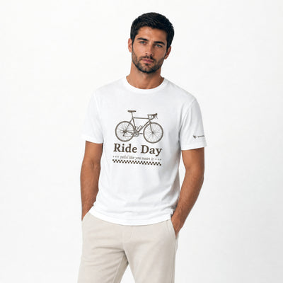 Man wearing a white t-shirt with a bicycle graphic and 'Ride Day' text on a white background