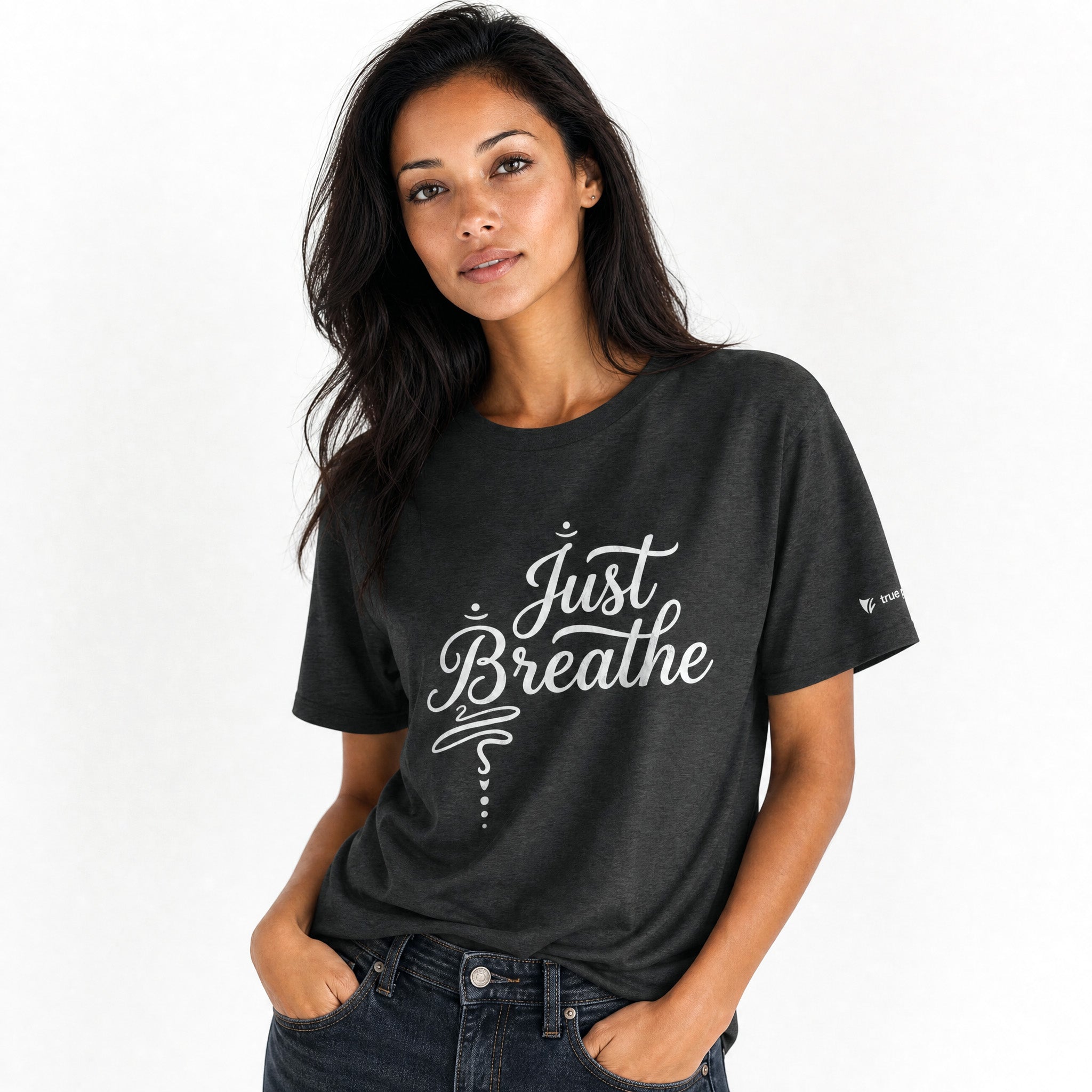 Woman wearing a dark heather grey t-shirt with 'Just Breathe' text on a white background